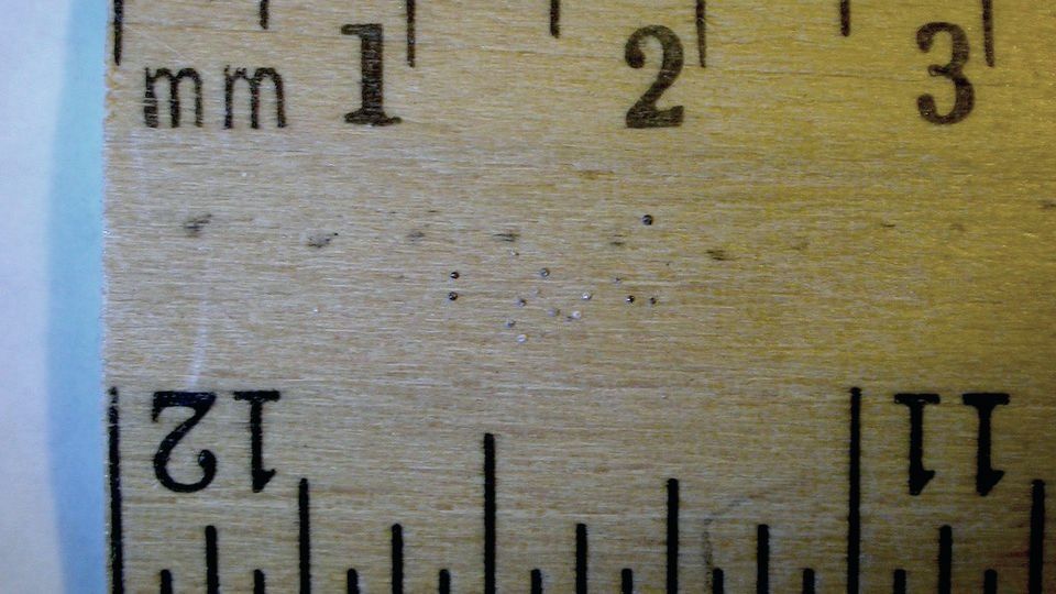 Close-up of the millimetre markings on a wooden ruler