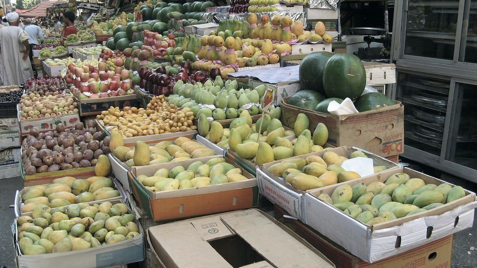 Fruit stacked in crates at a market stall