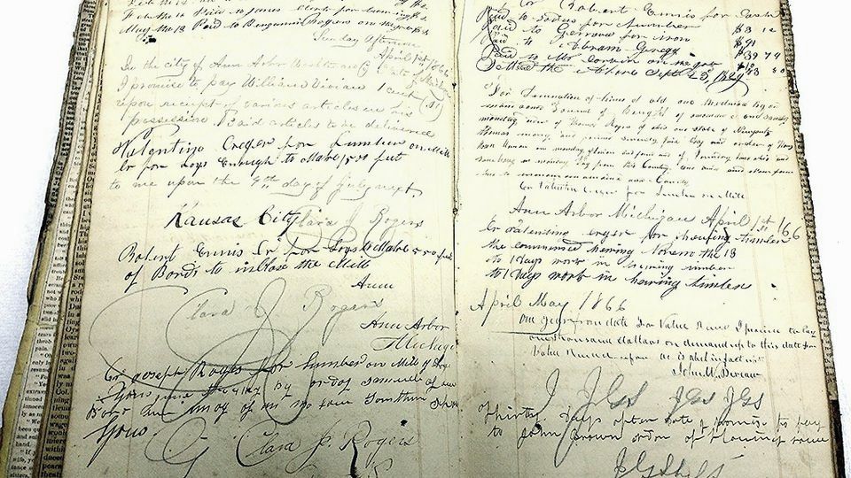 An old handwritten ledger book lying open