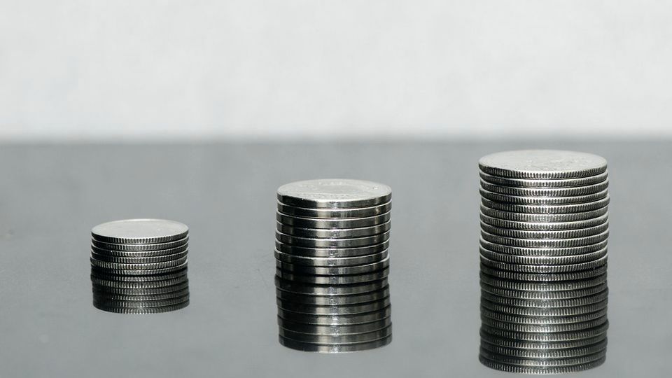 Three stacks of coins rising in height