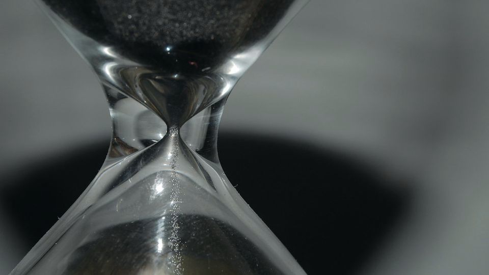 Sand running through an hourglass
